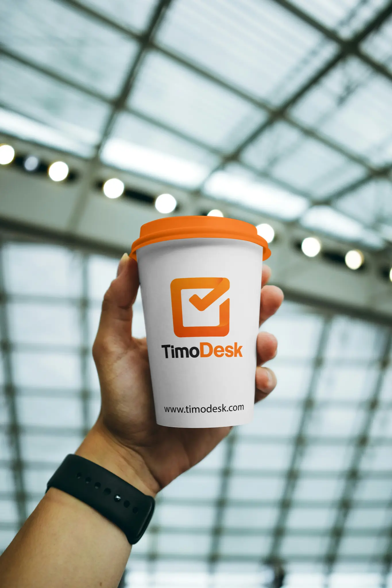 TimoDesk branding on a coffee cup